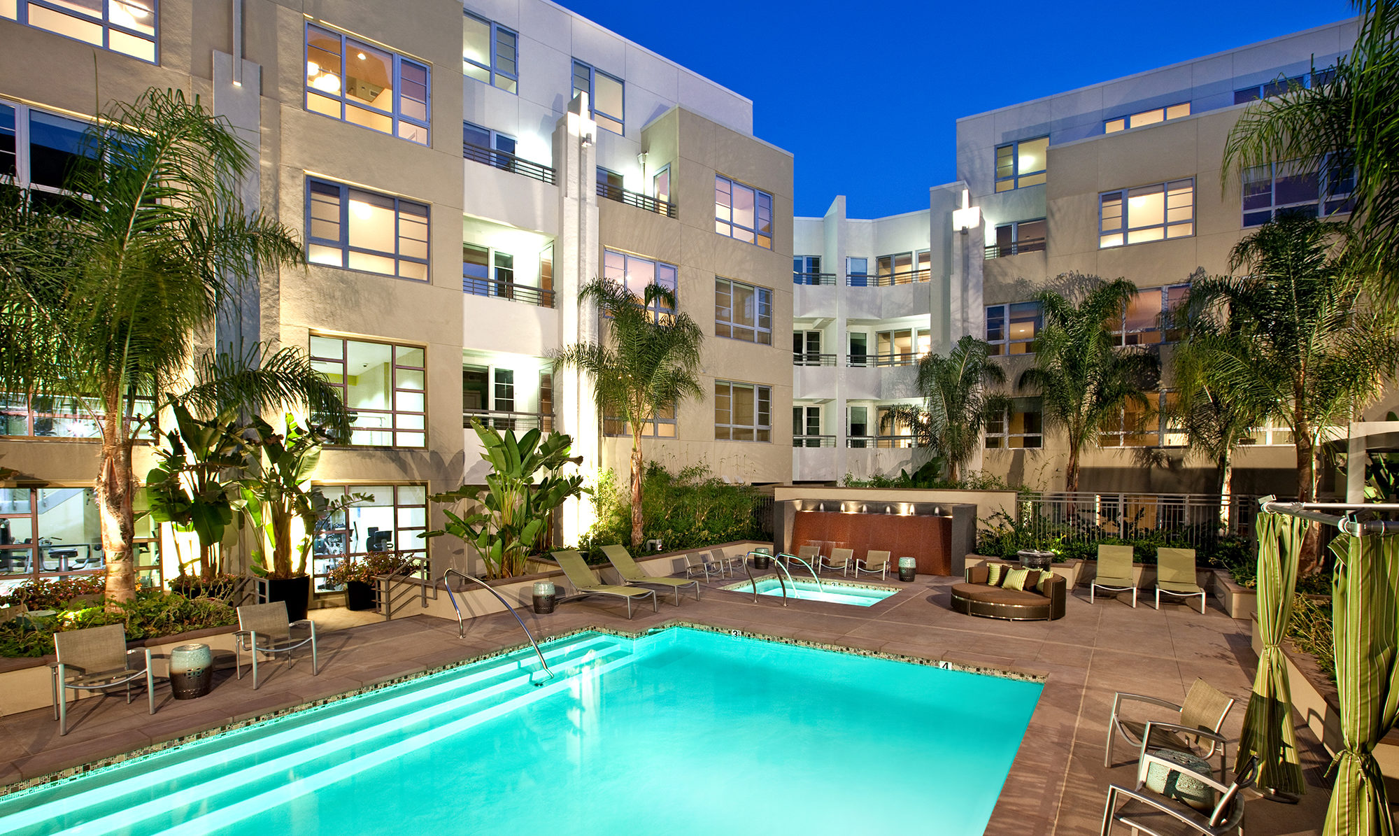 Large pool with apartment units wrapped around.