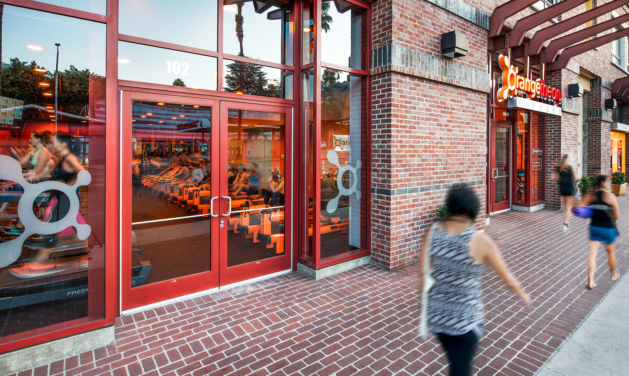 Retail level with red accents featuring Orange Theory