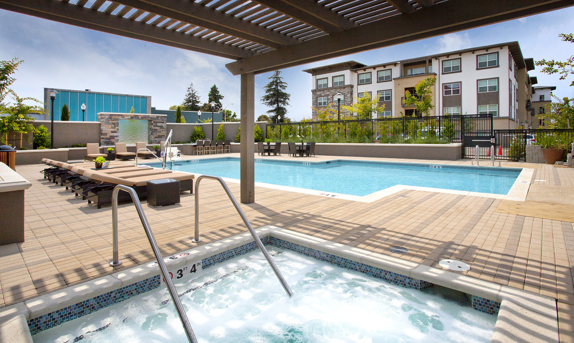 Pool area with jacuzzi and seating