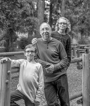 Headshot of Paul Anderson with his two sons