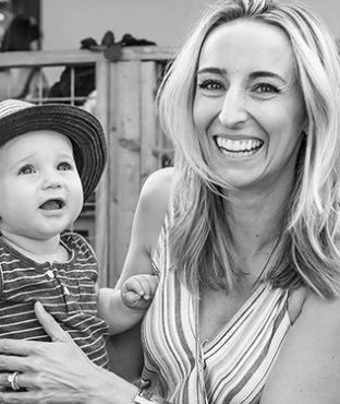 Headshot of Sara Schneider with her baby